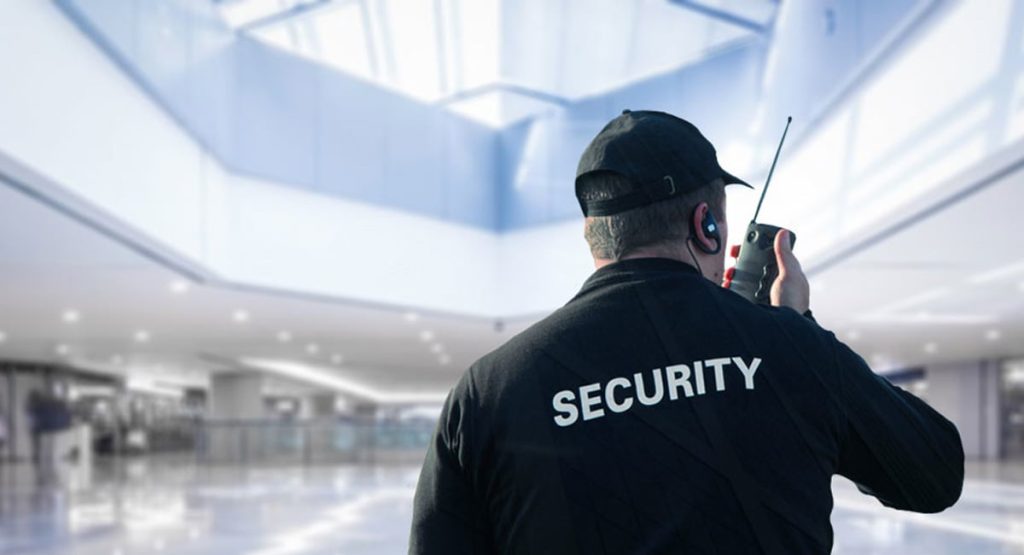 Security Guard Talking On Walkie-talkie